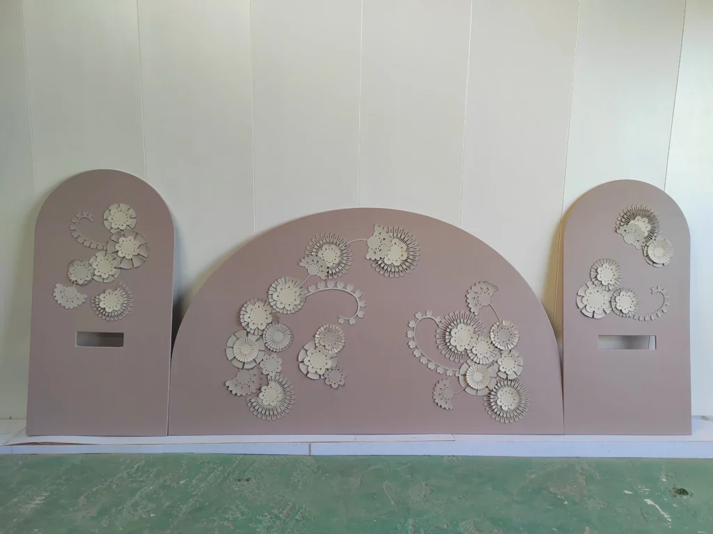 Luxury hotel interior featuring custom pink arched leather wall panels with illuminated 3D floral motifs
