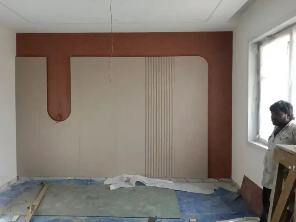 Behind the scenes on-site installation of a custom geometric 3D wall panel by Saipin Decor at a construction site.